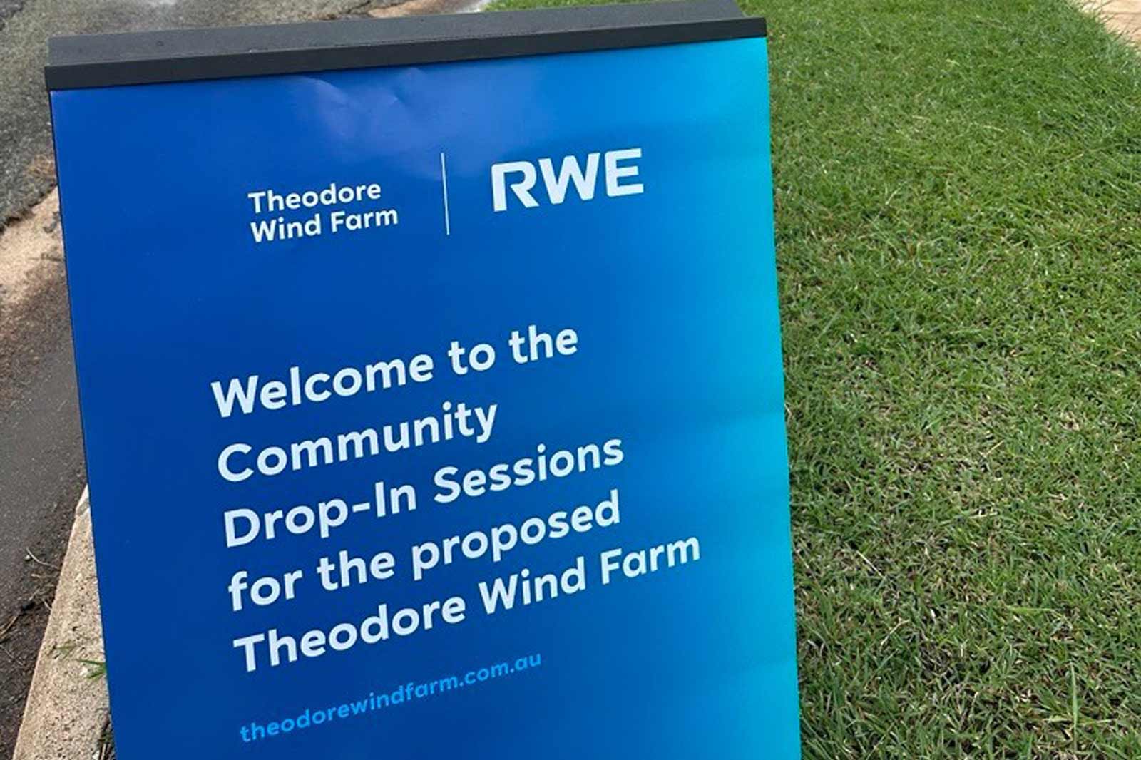 A sign welcoming the community to Drop-In Sessions for the proposed Theodore Wind Farm, featuring the logos of Theodore Wind Farm and RWE.